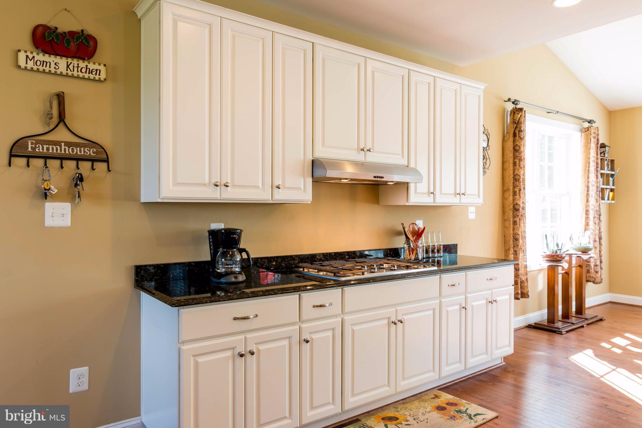 3333 Whispering Highland Road Finksburg, MD 21048 - Photo 12 of 30 a kitchen with stainless steel appliances granite countertop a sink and a white cabinets