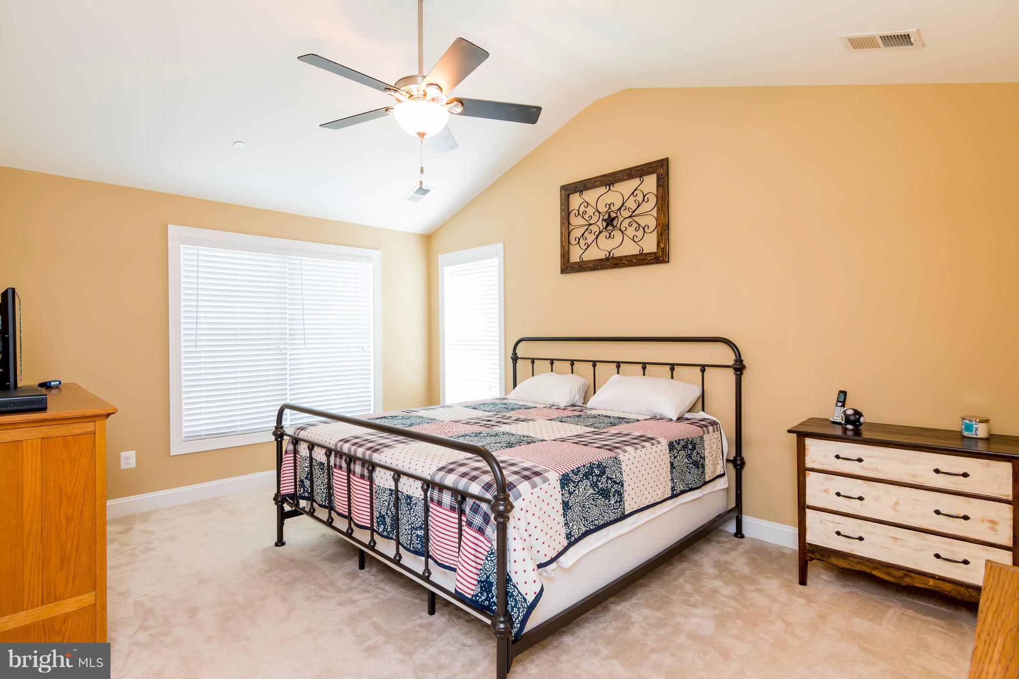 3333 Whispering Highland Road Finksburg, MD 21048 - Photo 17 of 30 a bedroom with a bed a dresser and a chandelier