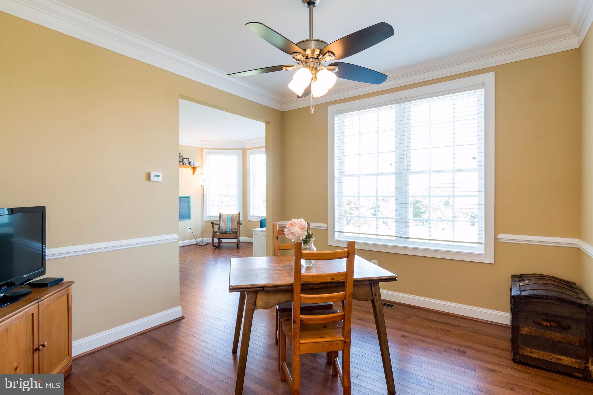 3333 Whispering Highland Road Finksburg, MD 21048 - Photo 5 of 30 a dining room with wooden floor and chandelier