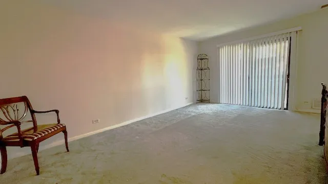 a view of a livingroom with furniture and a window