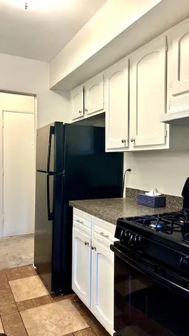 a kitchen with stainless steel appliances granite countertop a refrigerator and a stove
