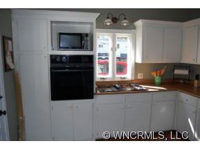 1594 Prince Road Columbus, NC 28722 - Photo 6 of 12 a kitchen with stainless steel appliances a stove microwave and sink