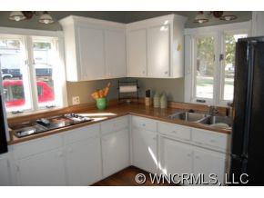 1594 Prince Road Columbus, NC 28722 - Photo 7 of 12 a kitchen with stainless steel appliances granite countertop a sink stove and cabinets