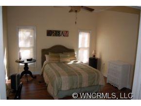 1594 Prince Road Columbus, NC 28722 - Photo 8 of 12 a bedroom with a bed and a lamp on dresser