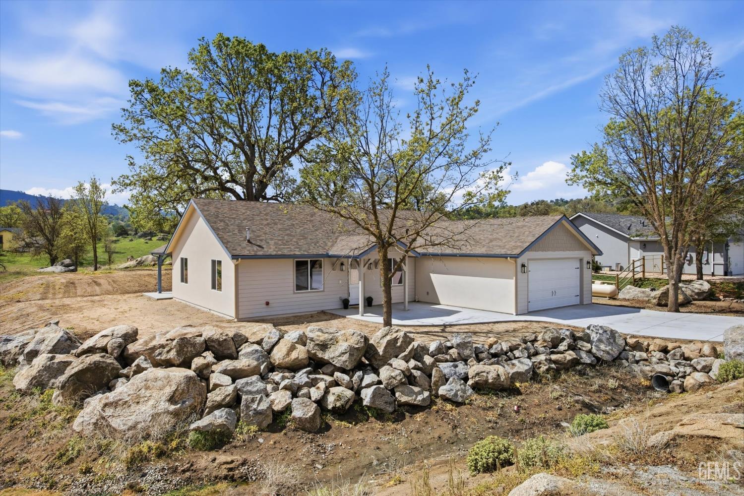 Undisclosed Address Tehachapi, CA 93561 - Photo 3 of 47 front view of a house with a large tree