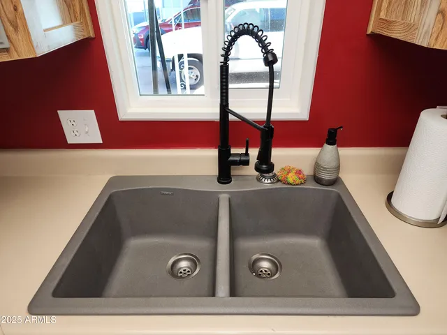 a bathroom with a sink a toilet a mirror and shower