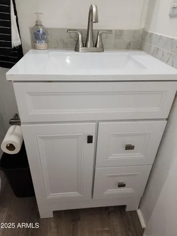 a bedroom with a bed and a tv on the dresser