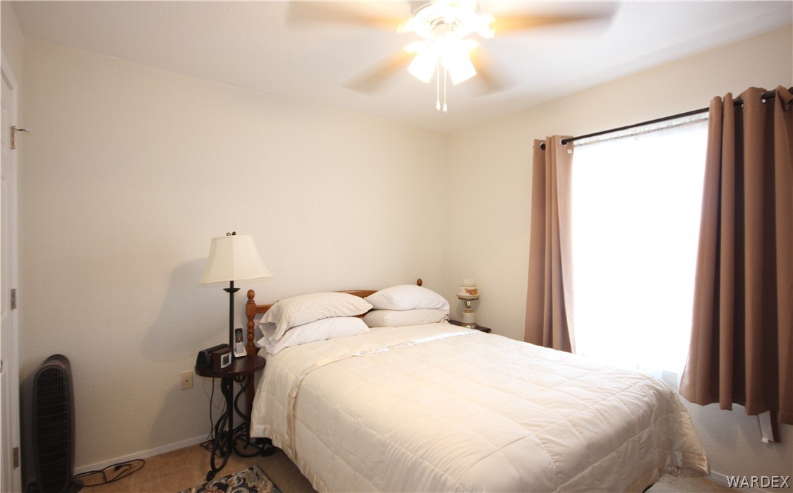 3408 Sunriver Road, Unit 109 Bullhead City, AZ 86429 - Photo 13 of 23 a bedroom with a bed and a chandelier