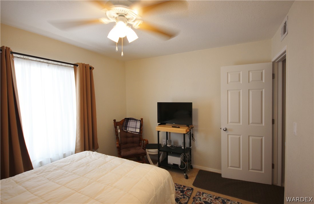 3408 Sunriver Road, Unit 109 Bullhead City, AZ 86429 - Photo 14 of 23 a bedroom with a bed and a flat screen tv