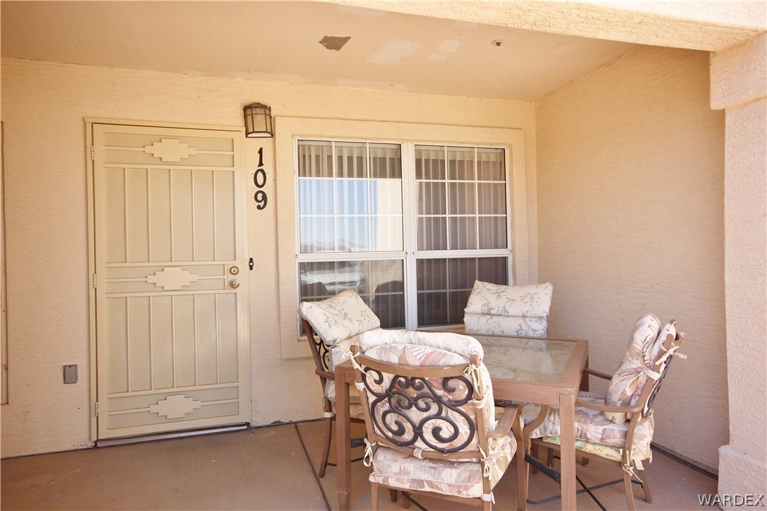 3408 Sunriver Road, Unit 109 Bullhead City, AZ 86429 - Photo 19 of 23 a view of a dining room with furniture window and outside view