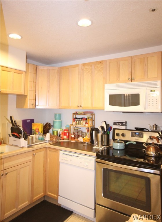 3408 Sunriver Road, Unit 109 Bullhead City, AZ 86429 - Photo 2 of 23 a kitchen with stainless steel appliances a sink a stove a microwave a refrigerator a window and cabinets
