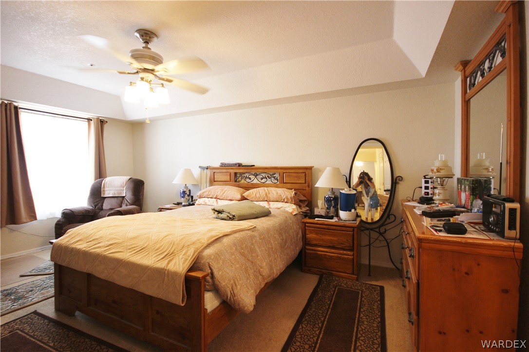 3408 Sunriver Road, Unit 109 Bullhead City, AZ 86429 - Photo 7 of 23 a bedroom with bed and a chandelier