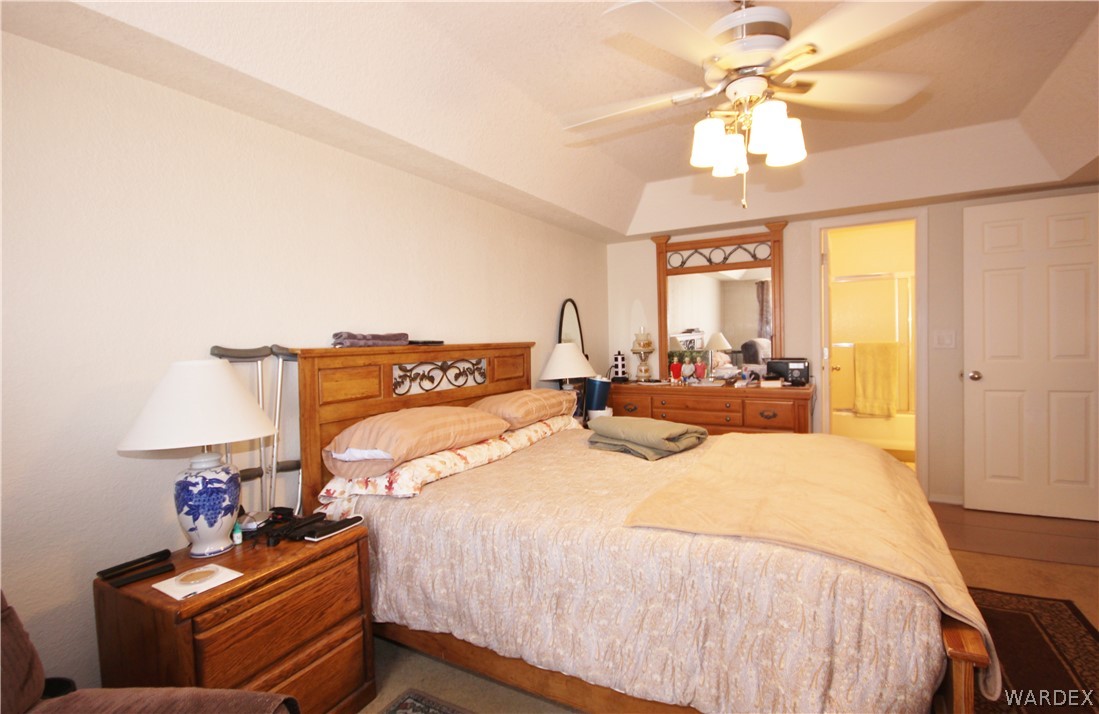 3408 Sunriver Road, Unit 109 Bullhead City, AZ 86429 - Photo 8 of 23 a bedroom with a bed and a chandelier