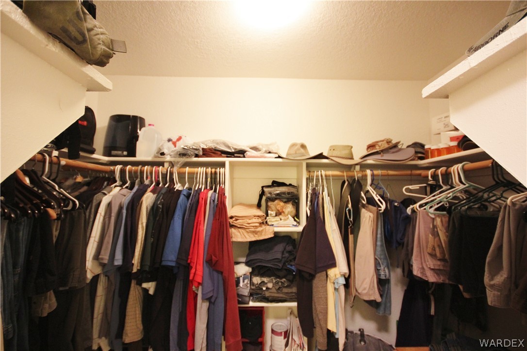 3408 Sunriver Road, Unit 109 Bullhead City, AZ 86429 - Photo 10 of 23 a view of walk in closet with clothes and shoes