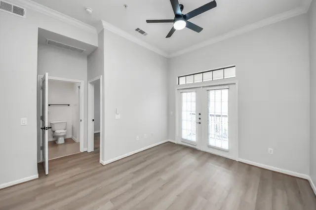 a kitchen with a refrigerator and white cabinets