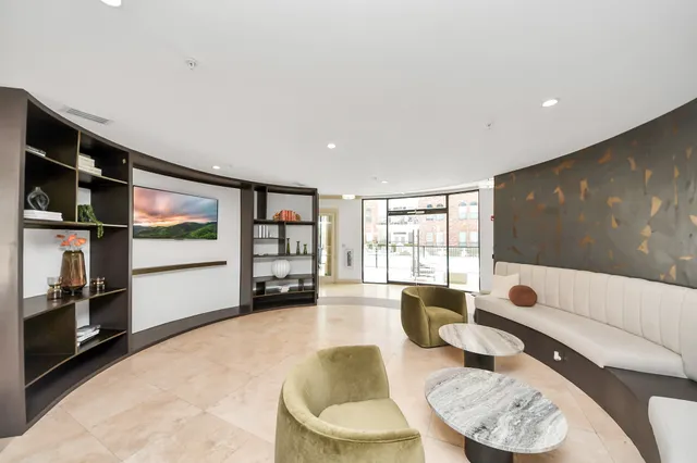 a kitchen with a couch and a large window