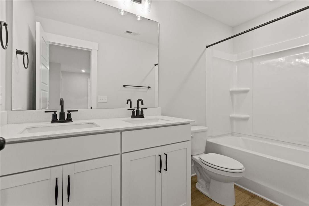 313 Old Shirley Road Central, SC 29630 - Photo 17 of 30 This sleek bathroom features dual sinks and a combined shower-tub, offering both convenience and style.