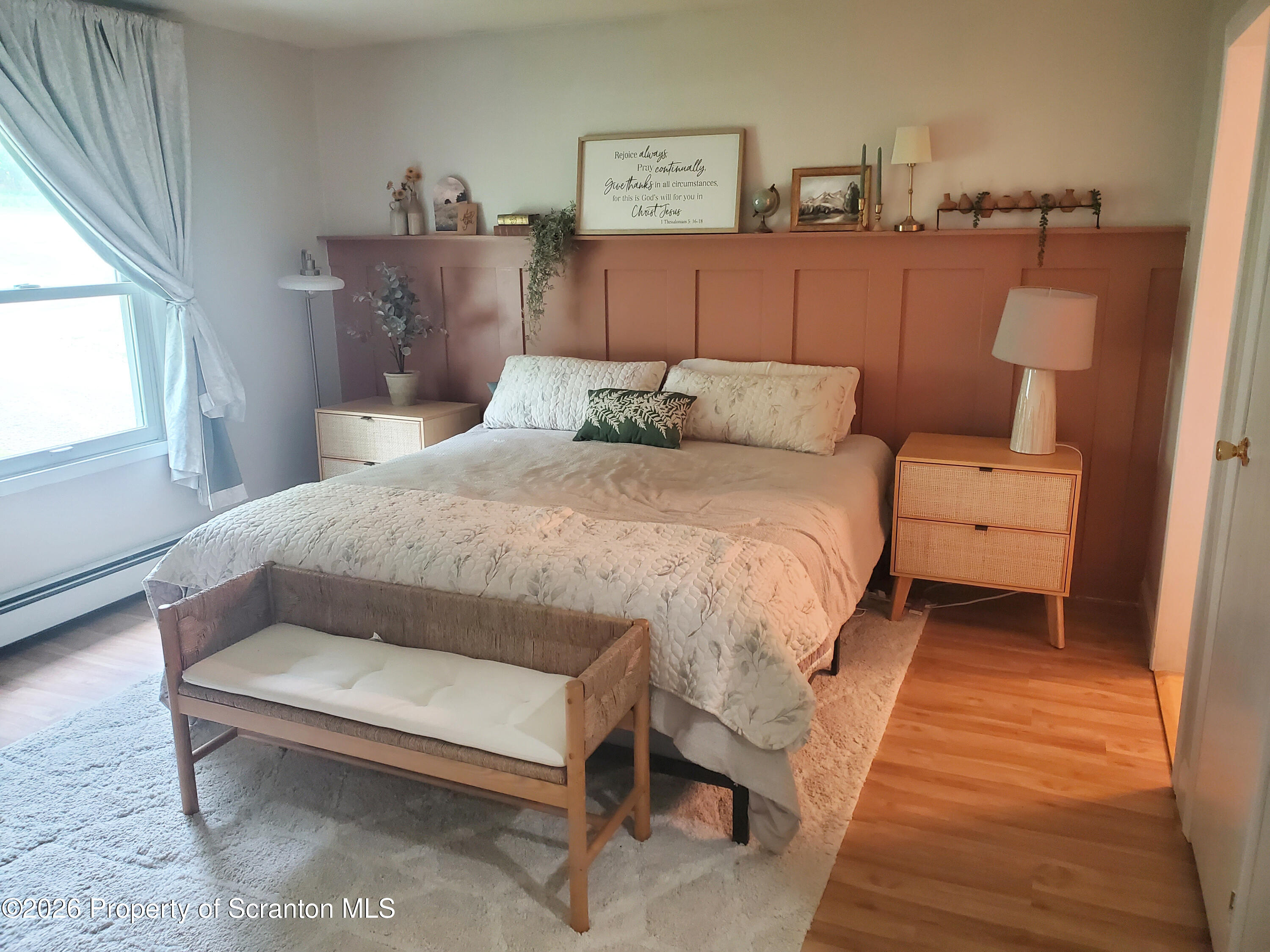 220 Brinkman Road Brackney, PA 18812 - Photo 14 of 32 a bed sitting in a bedroom next to a window with a lamp and a table