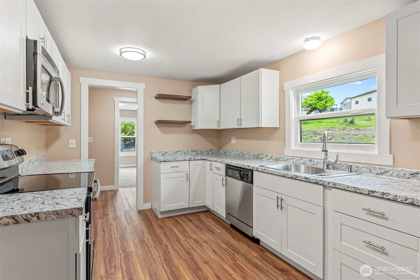 2914 Columbia Heights Road Longview, WA 98632 - Photo 17 of 29 a kitchen with granite countertop a sink stainless steel appliances and cabinets