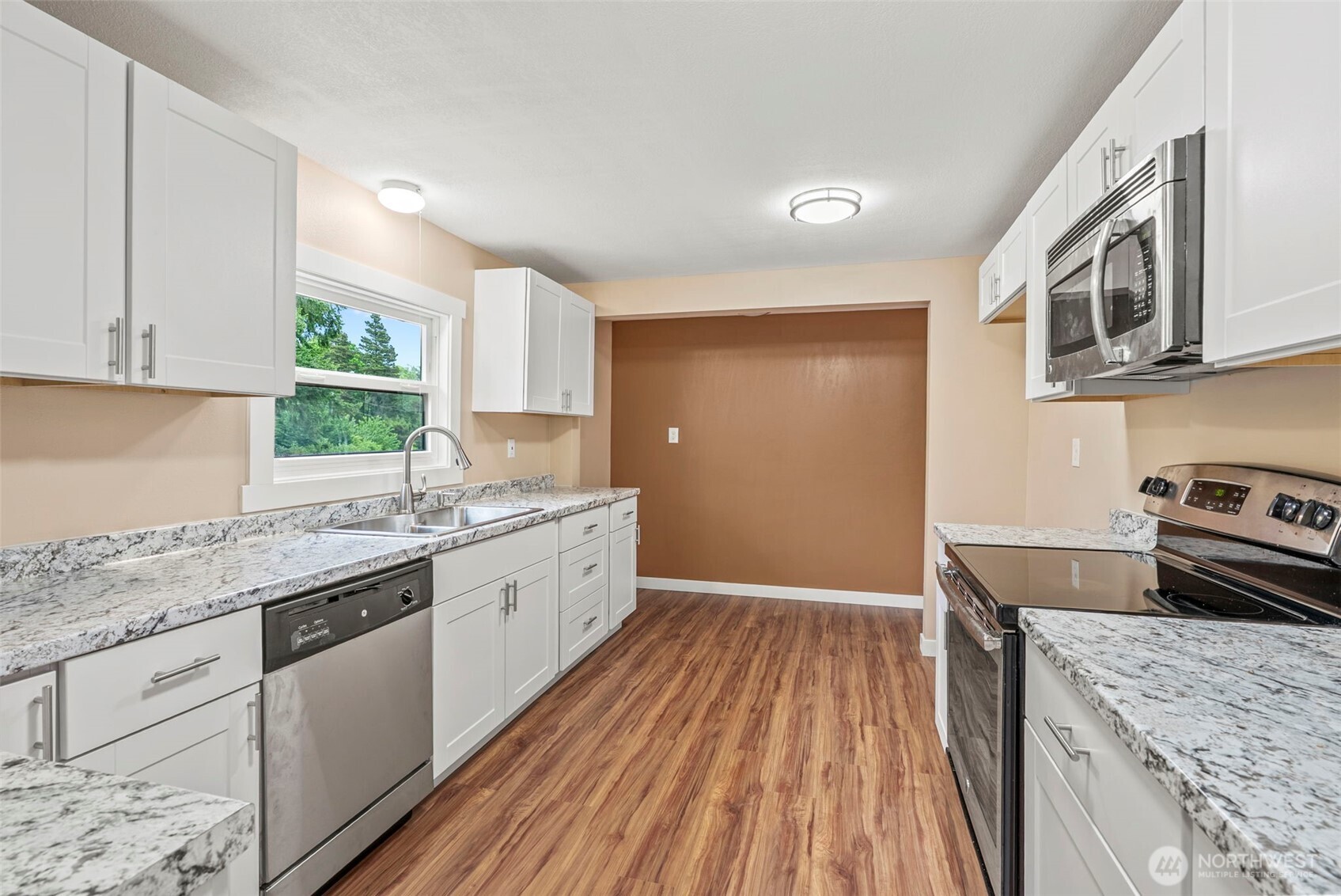 2914 Columbia Heights Road Longview, WA 98632 - Photo 18 of 29 a kitchen with granite countertop a sink a counter space appliances and cabinets