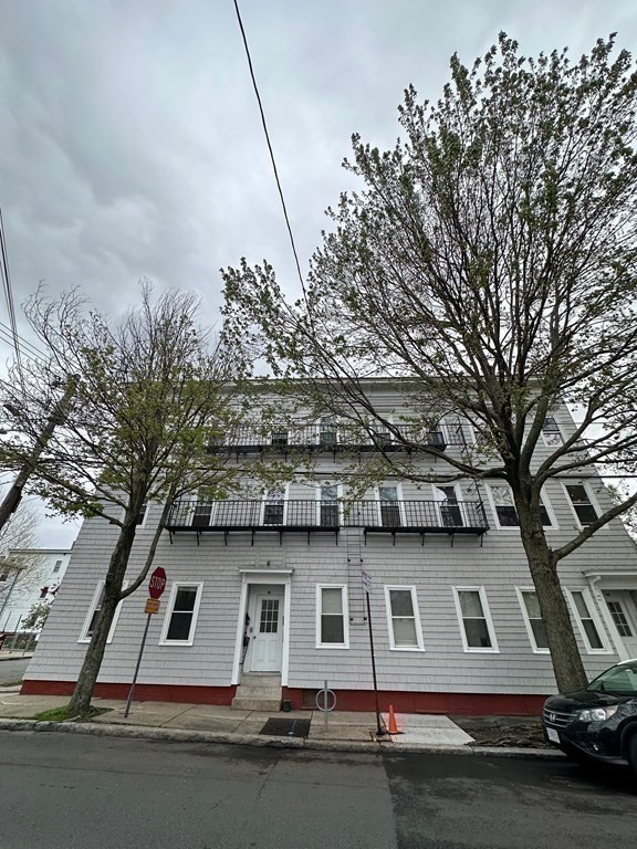 148 5th Street, Unit 2 Cambridge, MA 02141 - Photo 11 of 14 a view of a building with large trees