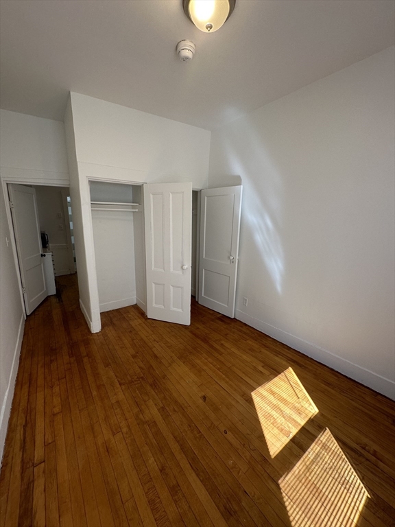 148 5th Street, Unit 2 Cambridge, MA 02141 - Photo 5 of 14 a view of empty room with wooden floor