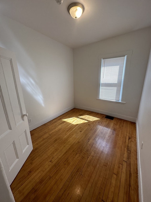 148 5th Street, Unit 2 Cambridge, MA 02141 - Photo 7 of 14 a view of empty room with wooden floor