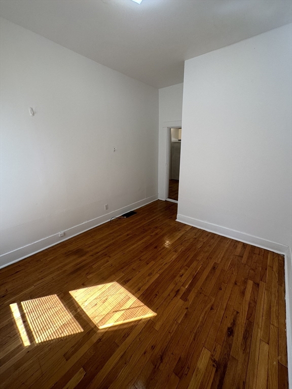 148 5th Street, Unit 2 Cambridge, MA 02141 - Photo 8 of 14 a view of empty room with wooden floor