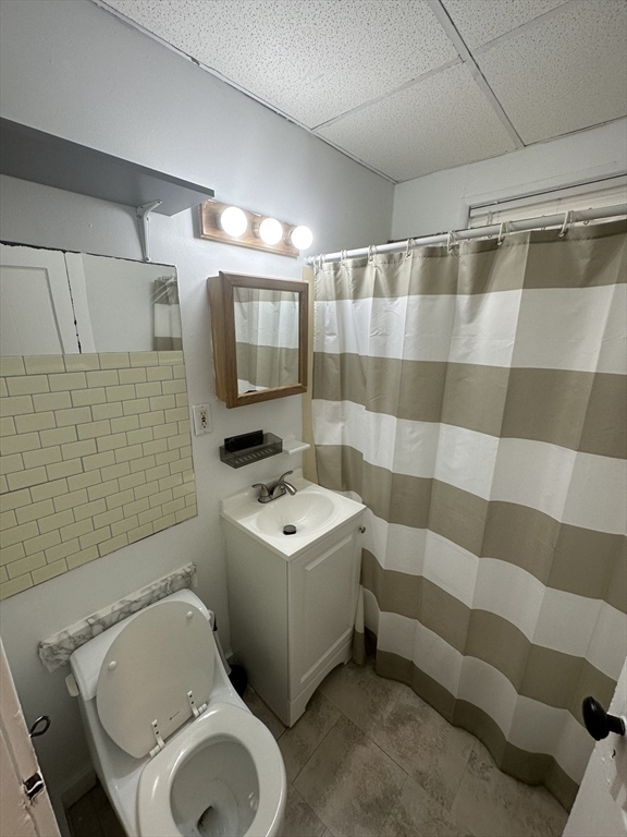 148 5th Street, Unit 2 Cambridge, MA 02141 - Photo 9 of 14 a bathroom with a sink toilet and shower