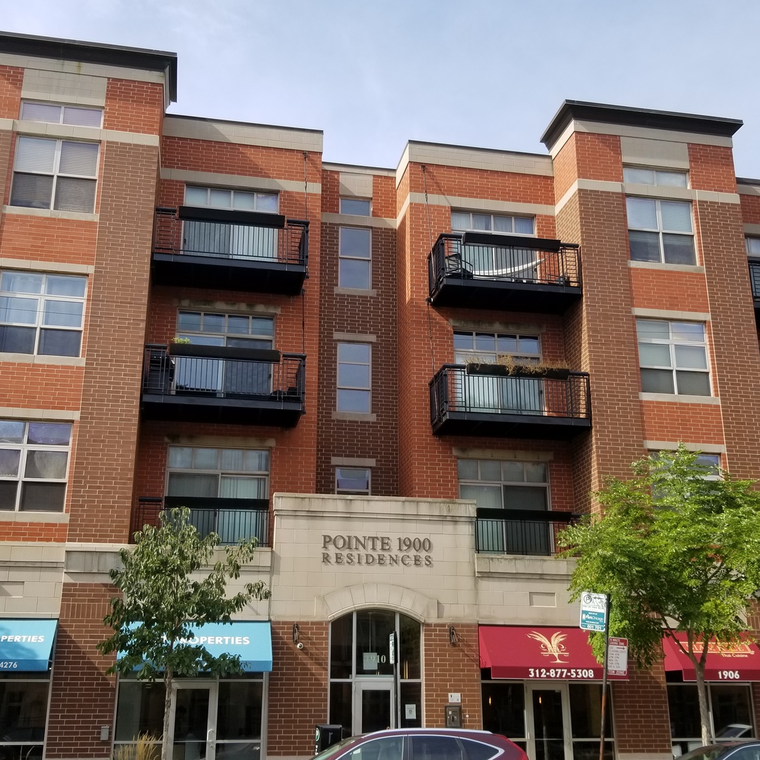 1910 South State Street, Unit 301 Chicago, IL 60616 - Photo 2 of 12 a front view of multi story residential apartment building with yard