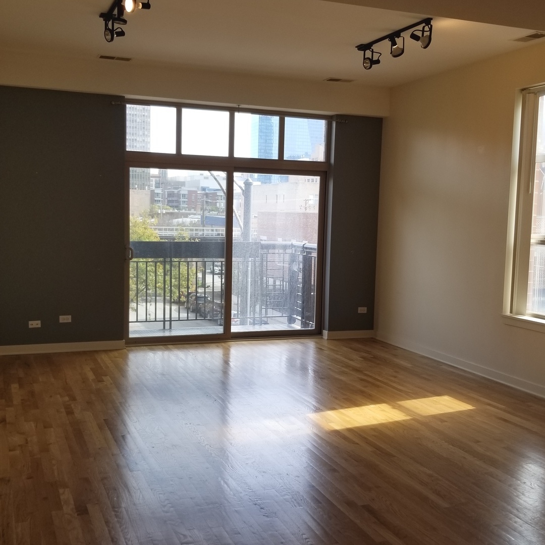 1910 South State Street, Unit 301 Chicago, IL 60616 - Photo 6 of 12 wooden floor in an empty room with a window