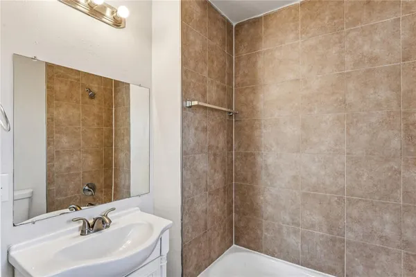 a bathroom with a sink a shower and a mirror