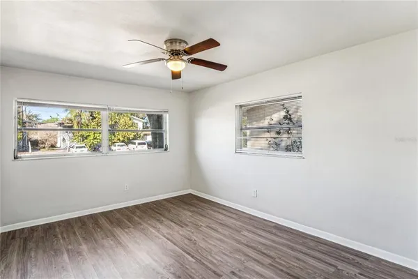 a view of empty room with wooden floor