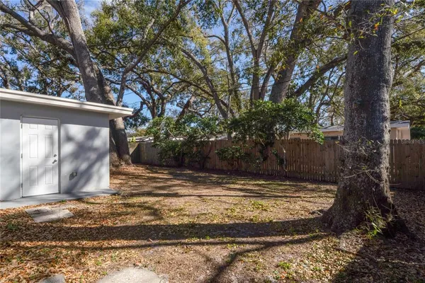 a view of a backyard with large trees
