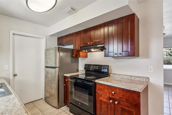 a kitchen with a stove and a refrigerator