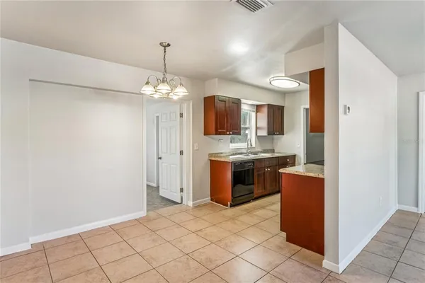 a spacious bathroom with a granite countertop sink a mirror and a shower