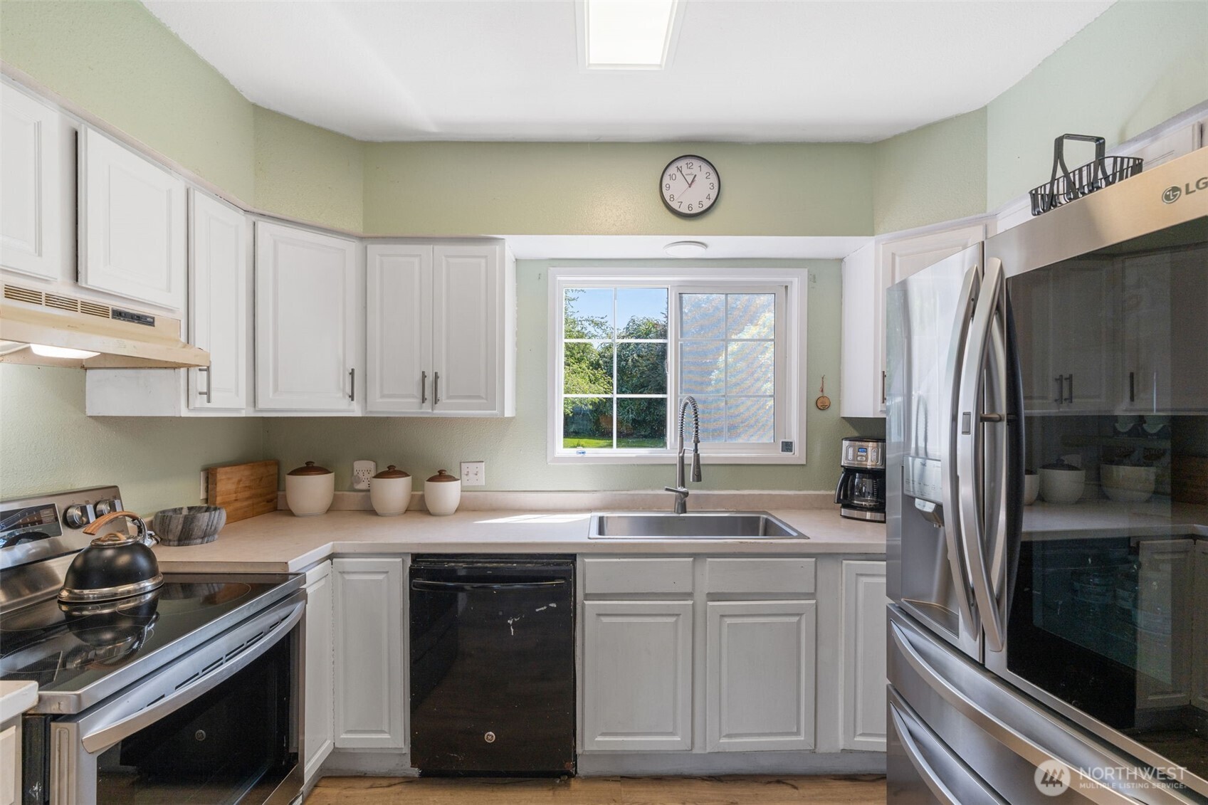 226 Southwest 16th Street Chehalis, WA 98532 - Photo 12 of 38 a kitchen with a sink stove and refrigerator