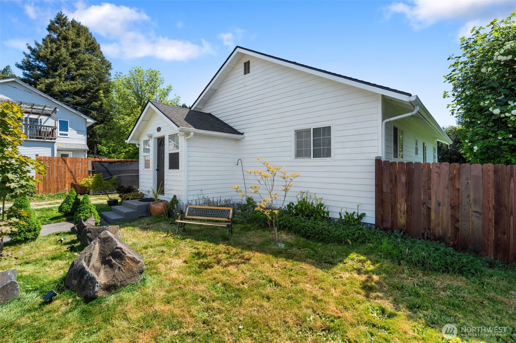 226 Southwest 16th Street Chehalis, WA 98532 - Photo 20 of 38 a view of backyard of house with wooden fence and large trees