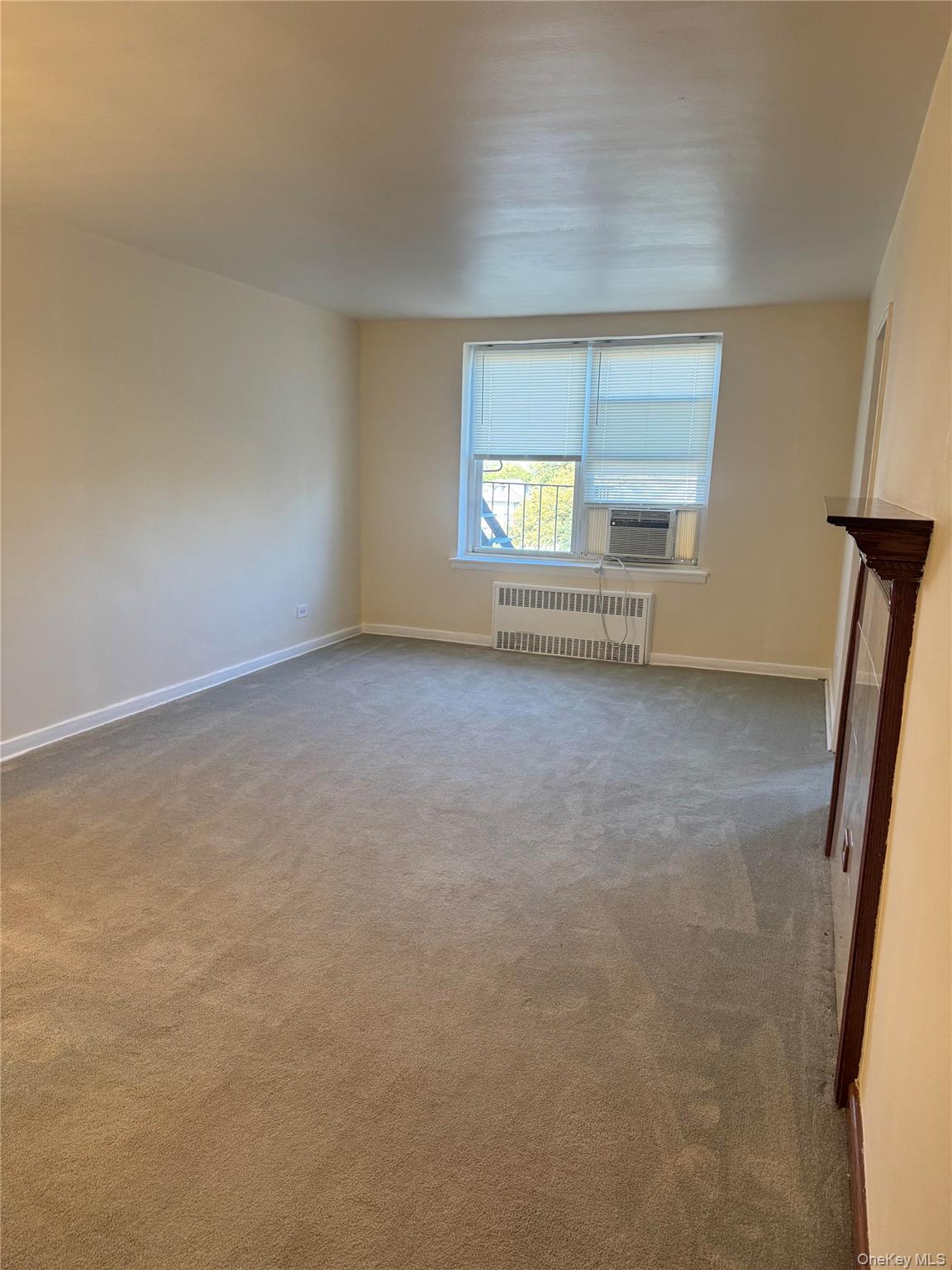 84-50 169th Street, Unit 306 Queens, NY 11432 - Photo 2 of 9 a view of a room with window and stairs