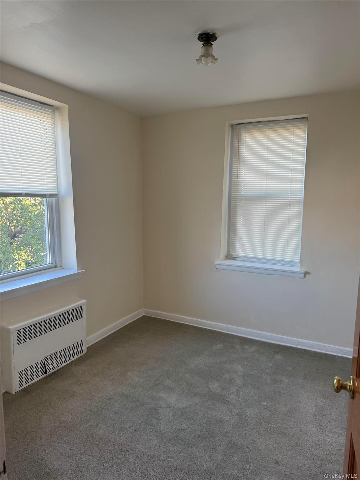 84-50 169th Street, Unit 306 Queens, NY 11432 - Photo 9 of 9 an empty room with a window