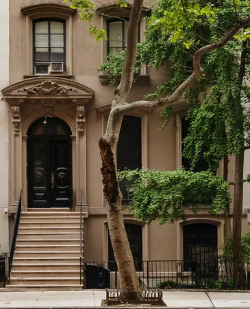 a front view of a house with plants