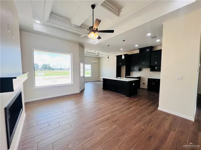 a view of kitchen with sink and wooden floor