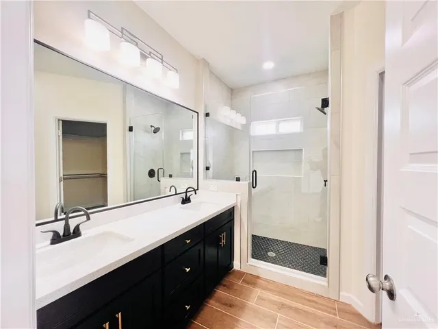 a bathroom with a double vanity sink mirror and double