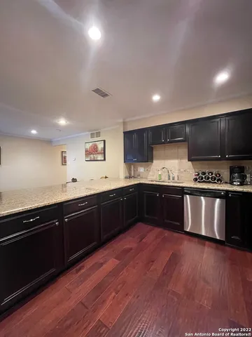 a large kitchen with lots of counter space and stainless steel appliances