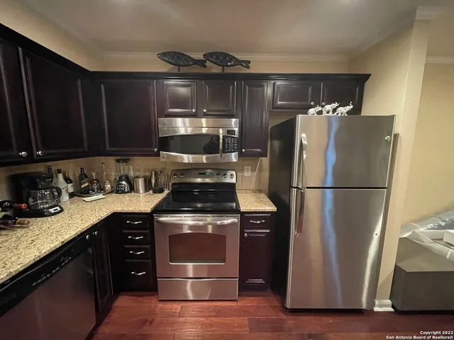 a kitchen with a refrigerator stove and sink