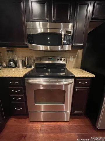 a stove top oven sitting inside of a kitchen