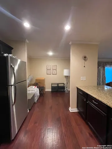 a kitchen with sink refrigerator and cabinets