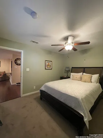 a bedroom with a bed and lamp