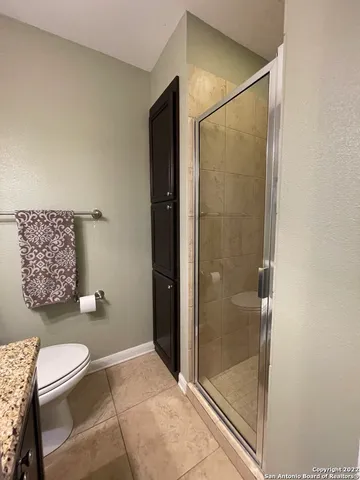a bathroom with a toilet and a shower