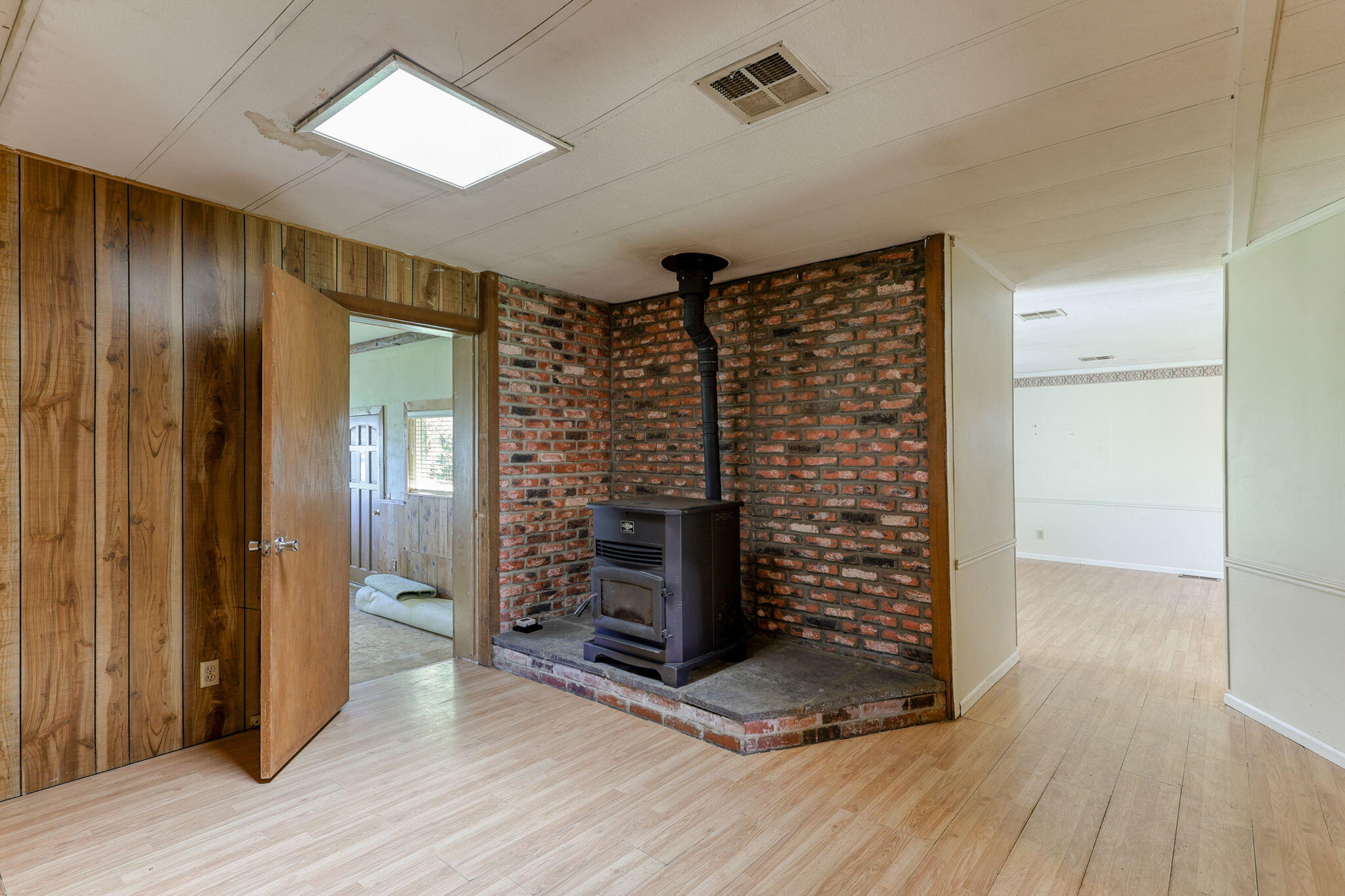 5082 Happy Valley Road Anderson, CA 96007 - Photo 13 of 66 wooden floor in an empty room with a wooden door